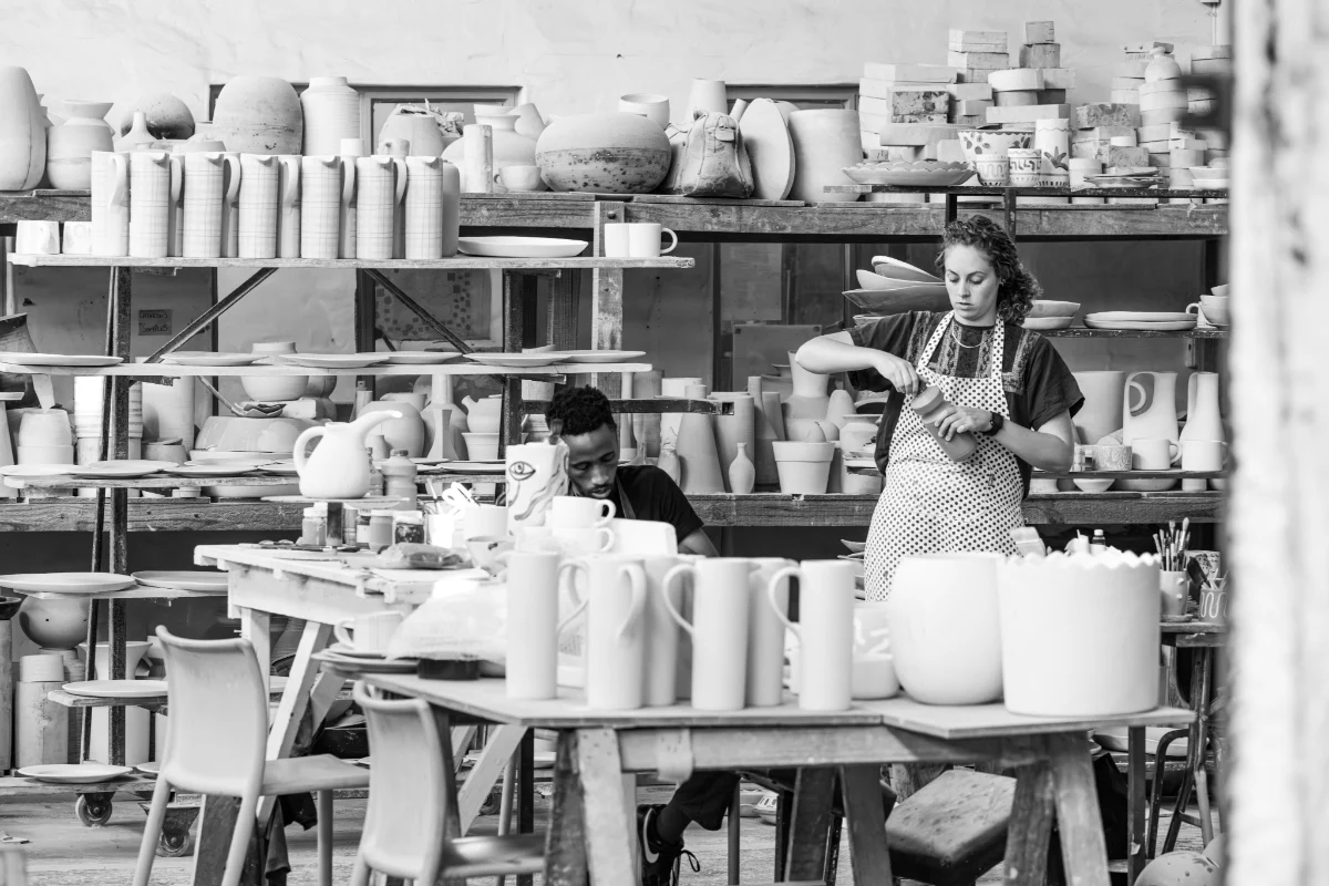 Ceramicists finishing handmade pieces in the Pret-a-pot workshop